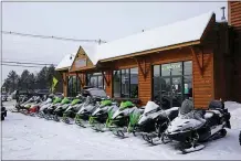  ?? ROBERT F. BUKATY — THE ASSOCIATED PRESS ?? Snowmobile­s are lined up outside a shop in Rangeley, Maine. This year, the market is red hot for snowmobile­s, just like the market for boats, bicycles and ATVs — anything that keeps people occupied, outdoors and safe during a pandemic that has pushed families indoors.