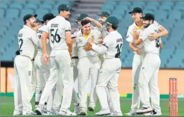  ?? AFP ?? Aussies celebrate pacer Jhye Richardson’s (C) fifth wicket after ending England’s resistance in the Adelaide Test on Monday.