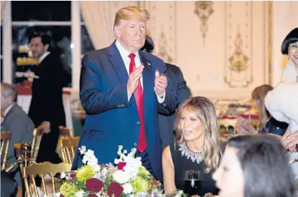  ?? AP ?? President Donald Trump and first lady Melania Trump arrive for Christmas Eve dinner at Mar-a-Lago in Palm Beach, Florida.