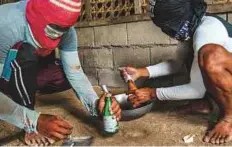  ?? New York Times News Service ?? Fishermen prepare homemade bombs used for illegal dynamite fishing in Bohol, the Philippine­s. Dynamite fishing destroys both the food chain and the corals where the fish nest and grow.