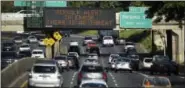  ?? ANTHONY QUINTANO — CIVIL BEAT (VIA AP) ?? Cars drive past a highway sign that reads “MISSILE ALERT ERROR THERE IS NO THREAT” on the H-1 Freeway in Honolulu on Saturday.