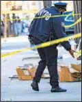  ??  ?? Cop check scene on Georgia Ave. in East New York, where man, 21, was shot and wounded early Saturday.