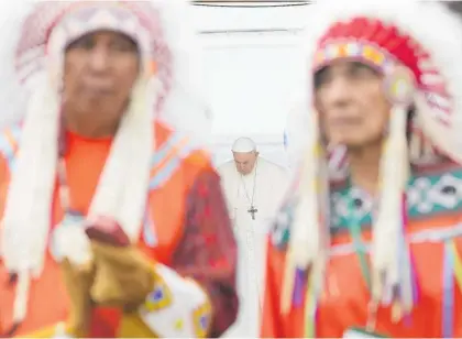  ?? Photo / AP ?? Pope Francis bows his head as Indigenous chiefs prepare to perform a traditiona­l ceremony.