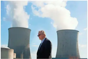  ?? USA TODAY NETWORK TENNESSEE FILE PHOTO ?? THEN-TVA President and CEO Bill Johnson pauses on Oct. 19, 2016, in front of the cooling towers at the Watts Bar Nuclear Plant in
Rhea County. Johnson was at the center of Memphis’ debate on whether to stay or leave the TVA.