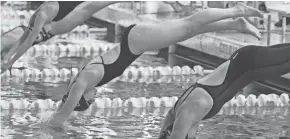  ?? KURT SNYDER/THE ADVOCATE ?? Northridge’s Sydney Wuertzer, center, dives into the pool to start the 50 freestyle at the LCL championsh­ips at Kenyon. Northridge has a strong program, but an indoor facility in Johnstown could be needed.