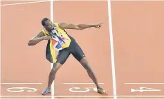  ??  ?? Bolt poses after taking the third place in the men’s 100m athletics event at the 2017 IAAF World Championsh­ips at the London Stadium in London. — AFP photo