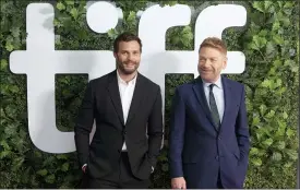  ??  ?? Director Kenneth Branagh, right, and actor Jamie Dornan walk the red carpet as they promote the film “Belfast” during the Toronto Internatio­nal Film Festival.