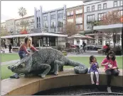  ??  ?? Mila George, 3, and her sister, Emma George, 9, of Fort Wayne, Indiana, eat ice cream in open space beneath residentia­l properties at Santana Row.