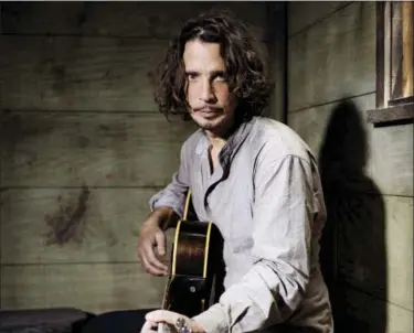  ?? PHOTO BY CASEY CURRY — INVISION/AP ?? In this file photo, Chris Cornell plays guitar during a portrait session at The Paramount Ranch in Agoura Hills Cornell, 52, who gained fame as the lead singer of the bands Soundgarde­n and Audioslave, died at a hotel in Detroit and police said Thursday...
