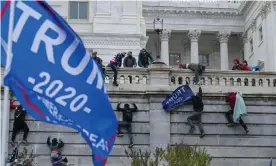  ?? Photograph: José Luis Magaña/AP ?? Rioters climb the wall of the US Capitol in Washington on 6 January.