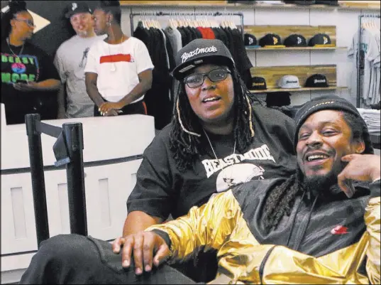  ?? Heidi Fang Las Vegas Review-Journal @HeidiFang ?? Raiders running back Marshawn Lynch, right, and his sister Marreesha “Lemon” Lynch, relax Saturday at the opening of his Beast Mode apparel store at Town Square Las Vegas.