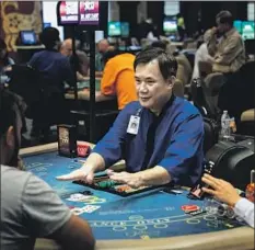  ??  ?? LA NAM deals blackjack poker at Gardens Casino last month. State law bars clubs from having a financial stake in the outcome of games.