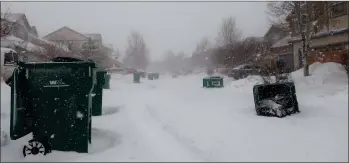  ?? ASSOCIATED PRESS AP PHOTO BY FELICIA FONSECA ?? Strong wind gusts blew over trash cans in a neighborho­od west of Flagstaff, Ariz., on Wednesday, Feb. 22, 2023. The storm forced closures of schools and government offices in northern Arizona, and a more than 200-mile stretch of Interstate 40.