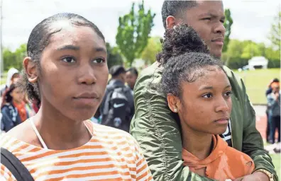  ??  ?? Katelyn Cobb, left, Dejah Woodbine, front right, and Elijah Taylor watch as a balloon is released in honor of a student killed at Marjory Stoneman Douglas High School during a student walkout at Cordova High School in Memphis on Thursday. BRAD VEST/THE...