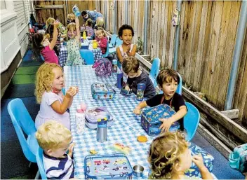  ?? EDUARDO CONTRERAS U-T ?? Students finish up a snack before playtime this month at Le Petite Etoile 360 Preschool in University Heights. In central San Diego, it costs $15,000 a year on average to send an infant to a licensed child-care center.