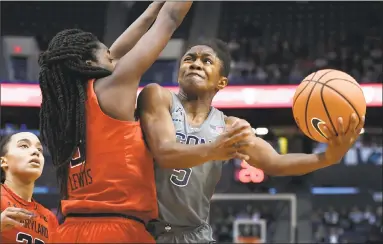  ?? Jessica Hill / Associated Press ?? UConn’s Crystal Dangerfiel­d, right, shoots around Maryland's Channise Lewis on Sunday.