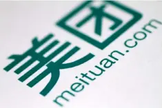  ??  ?? A company logo of China’s Meituan Dianping, an online food delivery-to-ticketing services platform, is displayed at a news conference on its IPO in Hong Kong, China. — Reuters photo