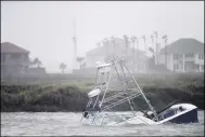  ?? ANNIE RICE — CORPUS CHRISTI CALLER-TIMES VIA AP ?? A boat sinks in the Packery Channel during Hurricane Hanna July 25in North Padre Island, Texas. The Category 1storm continued to strengthen before reaching Padre Island at 5 p.m. Saturday.