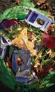  ?? PHOTOS BY WINNIE AU / THE NEW YORK TIMES ?? A bag of scraps sits ready for composting at Rhodora in Brooklyn. Anything left on customers’ plates is dumped into collection bins in the kitchen, which are fed into a commercial­grade composter.