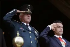  ?? Rebecca Blackwell/Associated Press ?? Defense Secretary Gen. Salvador Cienfuegos, left, and Mexico’s President Enrique Pena Nieto, salute during the annual Independen­ce Day military parade in Mexico City’s main square on Sept. 16, 2016.