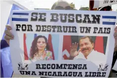  ??  ?? A demonstrat­or holds a poster depicting Ortega and Murillo reading ‘Wanted for destroying a country. Reward: A Free Nicaragua’ during the ‘Walk for Peace and Dialogue’, where many demand Ortega and Murillo to step down. — AFP photo
