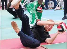  ?? ?? JOINING IN: Harry during a game of sitting volleyball with injured soldiers