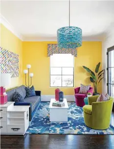  ?? Michael Hunter ?? A fourth-floor entertaini­ng room is devoted to color, with yellow walls, blue, pink and green furnishing­s and art in a rainbow of colors.