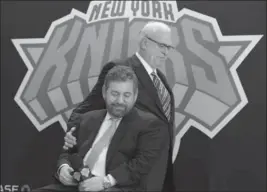  ?? RICHARD DREW, THE ASSOCIATED PRESS ?? In this March 2014 photo, New York Knicks president Phil Jackson puts his hand on team owner James Dolan, seated, during a news conference where Jackson wasintrodu­ced.