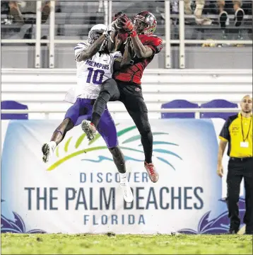  ?? ADAM SACASA / ASSOCIATED PRESS ?? Memphis cornerback Dontrell Nelson outwrestle­s Western Kentucky wide receiver Taywan Taylor for the ball and makes an intercepti­on in the end zone. But Taylor had nine catches for 144 yards and a TD.