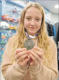  ??  ?? Jenna McLean with her medal. Abrightsid­e Photograph­y.