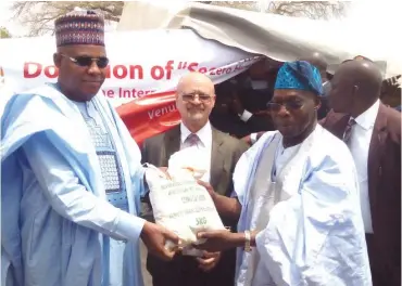  ??  ?? From left: Governor Kashim Shettima of Borno State; Deputy Director, Internatio­nal Institute of Tropical Agricultur­e (IITA) Dr Kenton Dashiell and former President Olusegun Obasanjo at the donation of 35,930 kilograms of seeds to Borno State Government...