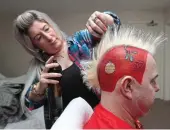  ??  ?? HAIR WEGO: Peter Wright turns into his ‘Snakebite’ alter ego with a little help from wife Jo