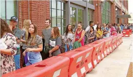  ?? [PHOTO BY GRAYSON COOK, THE OKLAHOMAN] ?? Potential “American Idol” contestant­s await their turn.