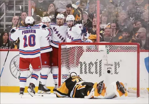  ?? Gene J. Puskar / Associated Press ?? The New York Rangers' Chris Kreider (20) celebrates after scoring against the Pittsburgh Pirates during the second period in Game 6 of a first-round playoff series in Pittsburgh on Friday.