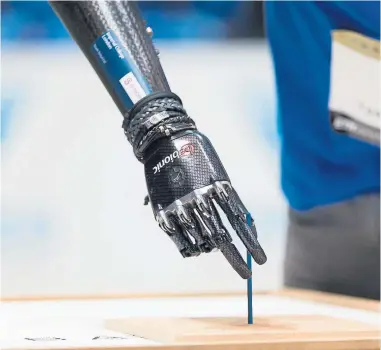  ??  ?? The Scottish bionic arm is demonstrat­ed at the 2016 Cybathlon Photograph: Nicola Pitaro