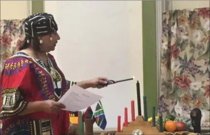  ?? KEVIN MARTIN — THE MORNING JOURNAL ?? Mistress of Ceremonies Joanne Eldridge Tucker participat­es in Kwanzaa celebratio­ns at the Harrison Cultural Community Centre in Lorain on Dec. 27.