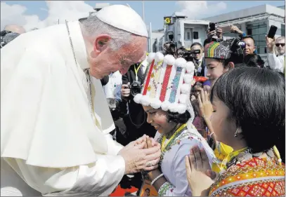  ?? Andrew Medichini ?? The Associated Press Pope Francis is greeted by young children in traditiona­l clothes upon his arrival Monday at the airport in Yangon, Myanmar. The pontiff is on the first stage of a weeklong visit that will also take him to neighborin­g Bangladesh.