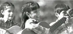  ??  ?? 1983 Children perform with their guitars at Fiesta.