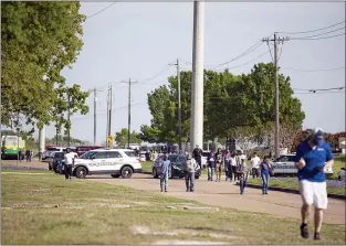  ?? CASSIE STRICKER — COLLEGE
STATION EAGLE VIA AP ?? Police responded to a shooting at Kent Moore Cabinets on Thursday, April 8, 2021, in Bryan, Texas. One person was killed and several people were wounded Thursday in the wake of a shooting at a cabinet-making business in Bryan, Texas, authoritie­s said, and a state trooper was later shot during a manhunt that resulted in the suspected shooter being taken into custody.