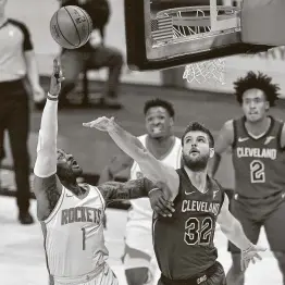  ?? Jason Miller / Getty Images ?? The Rockets’ John Wall shoots over Dean Wade during the third quarter when the game was still in doubt before the Cavaliers pulled away in the fourth.