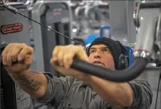  ?? Alexandra Wimley/Post-Gazette ?? John Fetterman works out at Crunch Fitness gym before sunrise Dec. 12 in Homestead. Mr. Fetterman has made waking up before dawn to go to the gym part of his daily routine.