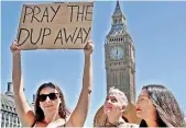  ?? AP ?? People demonstrat­e in Parliament Square against the Conservati­ve and DUP coalition government. —