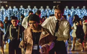  ?? PHOTO VINCENT OSUNA ?? Hayden Hulsey (right) helps his dance partner Lisa Duarte through the steps of “Cha Cha Slide” during the second annual Night to Shine event held Friday night at Imperial Valley College in Imperial.