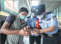  ?? XU CHENG / FOR CHINA DAILY ?? Police officers help a resident in need.