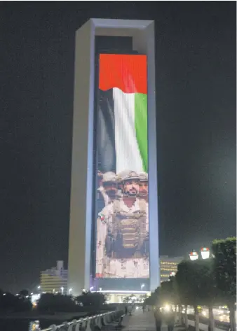  ?? Khushnum Bhandari for The National ?? The Adnoc building in Abu Dhabi featured a series of projected images and messages to welcome Sheikh Zayed bin Hamdan yesterday