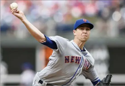  ?? MICHAEL PEREZ — THE ASSOCIATED PRESS ?? New York Mets starting pitcher Jacob deGrom throws during the first inning of Saturday’s game against the Philadelph­ia Phillies. DeGrom pitched his first complete game of the season as the Mets beat the Phillies 3-1.