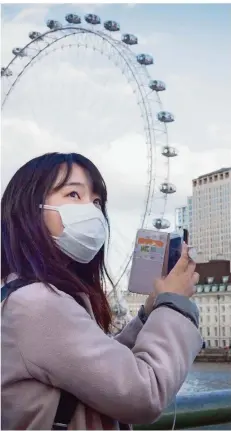  ?? FOTO: STEFAN ROUSSEAU/DPA ?? Tourismus mit Mundschutz, hier in London. Selbst damit dürfte es weltweit bald vorbai sein.