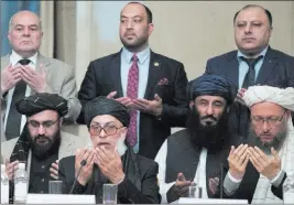  ?? Pavel Golovkin The Associated Press ?? Taliban political chief Sher Mohammad Abbas Stanikzai, first row second from left, prays with other Taliban officials Wednesday during “intra-afghan” talks in Moscow.