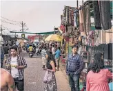  ?? BRYAN DENTON THE NEW YORK TIMES ?? Tourists walk through a flea market in Goa, India, where coffeehous­es are being replaced by discos.