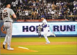  ?? Kevork Djansezian Getty Images ?? DODGERS FIRST BASEMAN Freddie Freeman rounds the bases after hitting a two-run home run in the first inning against the Giants in the series opener.